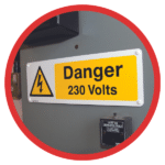 A Danger, High Voltage sign on the side of a piece of machinery