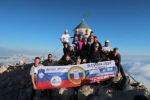 Small Act, Big Impact: Triglav Trek 2022- On top of the mountain banner picture